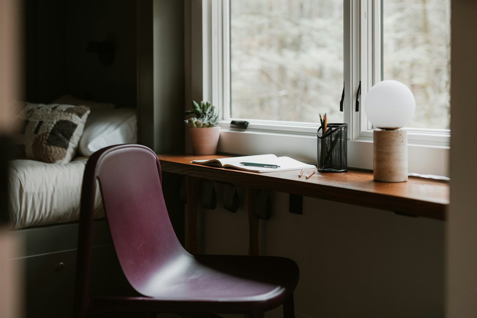 Heller Arbeitsplatz mit Schreibtisch und sorgfältig angeordneten Alltagsgegenständen